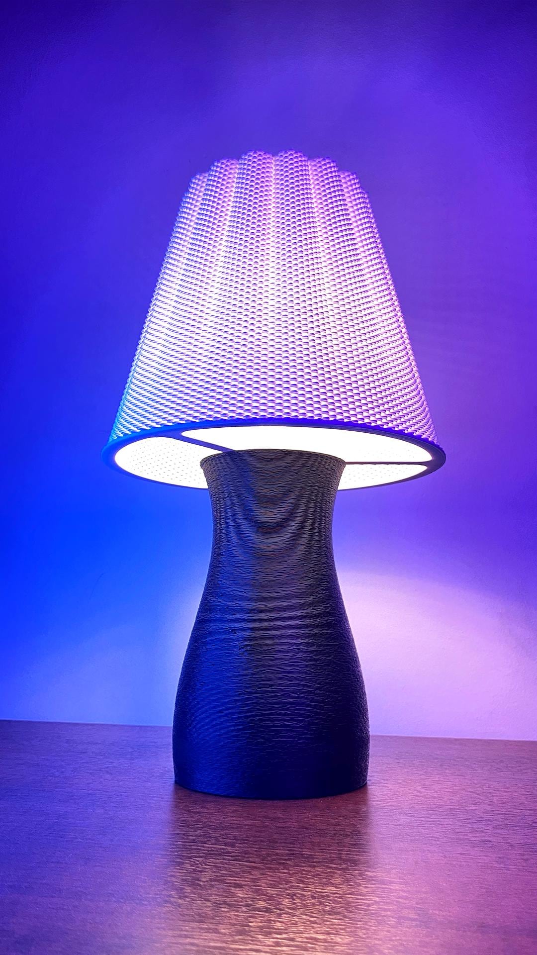 Lamp with a unique design on a wooden surface against a purple background