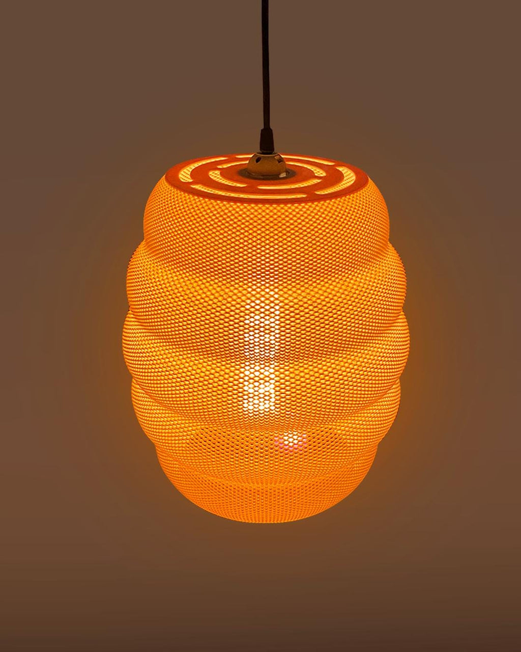 Mesh pendant light with a warm glow on a dark background