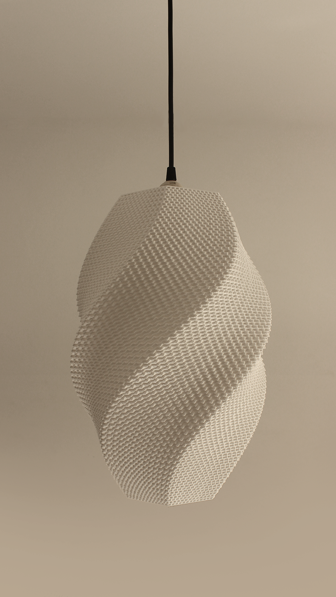 Textured white pendant light hanging against a beige background