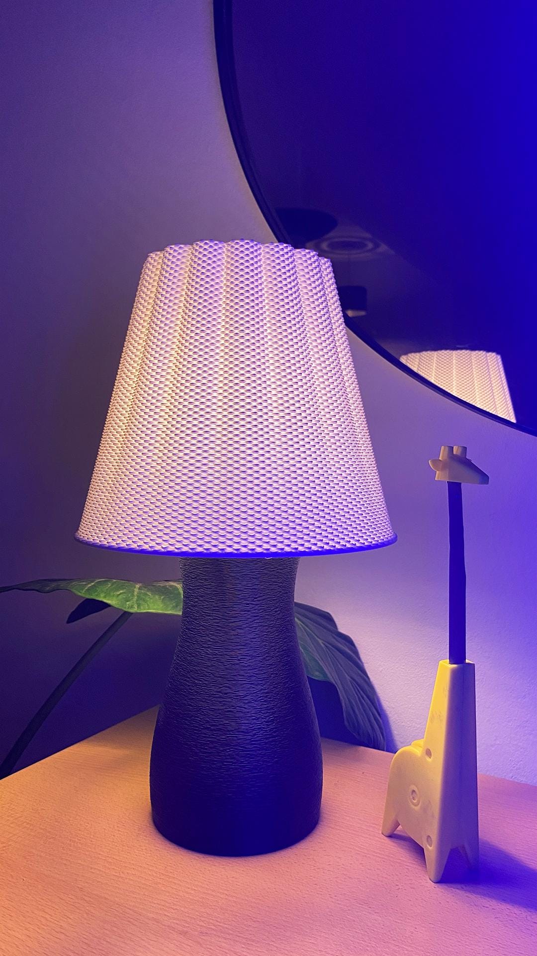 Table lamp with a textured white shade on a purple background