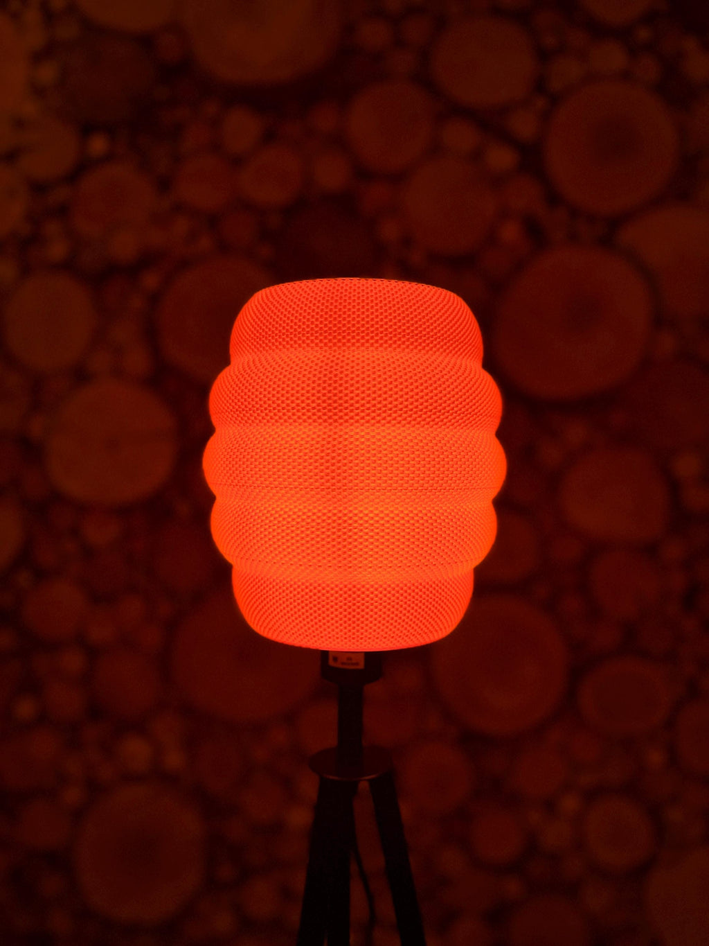 Orange textured lampshade against a dark background