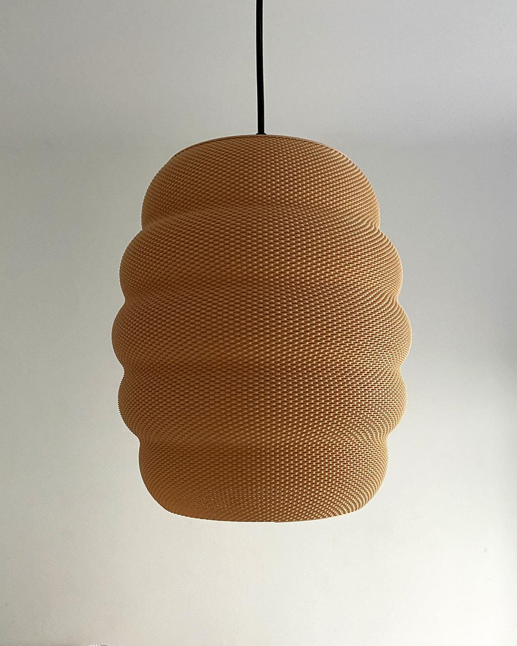 Brown textured pendant light against a plain background
