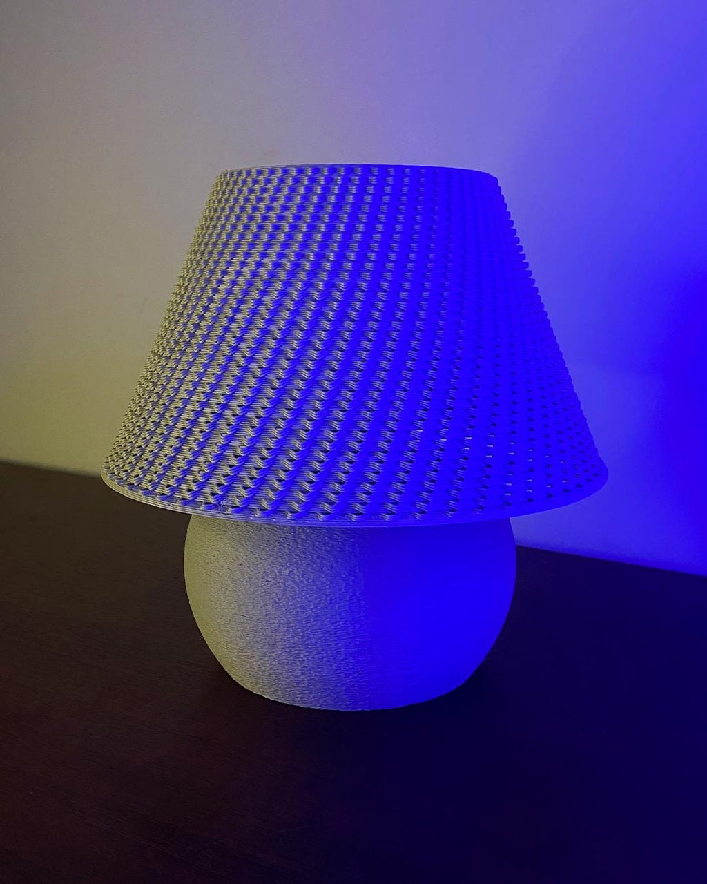Lamp with blue textured shade on a dark background